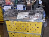 a cart that has many items on it in a warehouse
