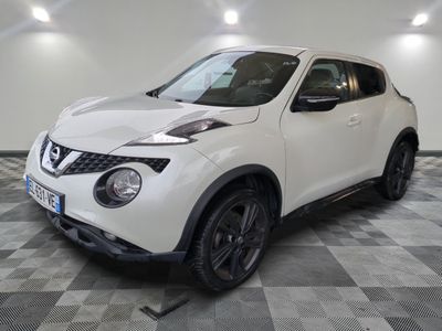 the white nissan juke suv is parked in the garage