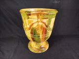 a glass vase with a yellow and green design on it