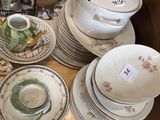 a lot of dishes and cups on a wooden table
