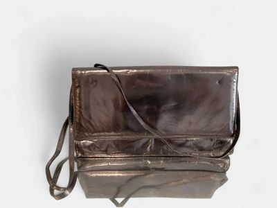 brown leather purse on white background with strap and shoulder strap