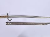 pair of old and worn swords on a white surface