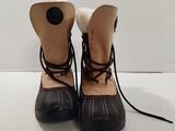 pair of black and white shoes with laces on them sitting on a white surface