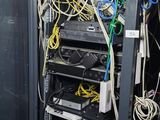 a rack of wires in a room with a blackboard on the wall