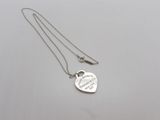 a silver heart shaped necklace with a message on it