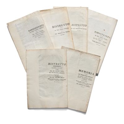 five old books are stacked on top of each other on a white surface