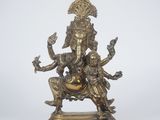 a bronze statue of a woman sitting on a chair