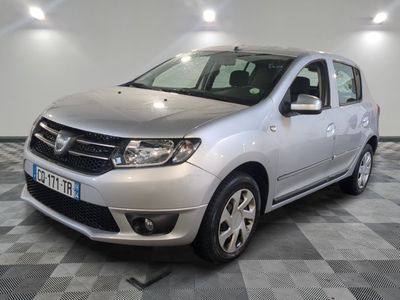 une photo d'une Dacia argentée garée sur un sol à damier