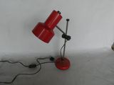 a red lamp that is sitting on a table