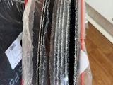 a red wire rack holding a bunch of black and white plates