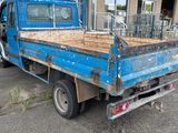 a blue truck that is parked in front of a building