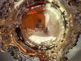 a silver plate with a gold design on it