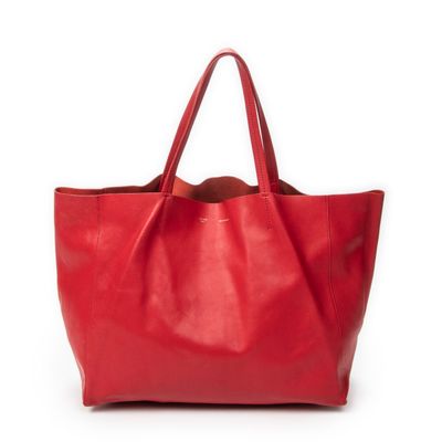 a red leather tote bag on a white background
