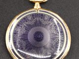 an image of a close up of a pocket watch on a table