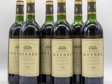 six bottles of wine are lined up on a white surface