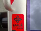 a close up of a cell phone with a red sticker on it