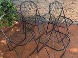 three chairs that are sitting on a patio