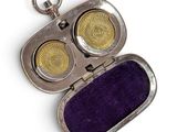 an image of a silver case with two yellow eyes inside of it