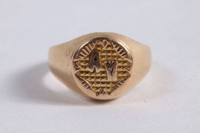 an image of a gold ring with a masonic symbol on it