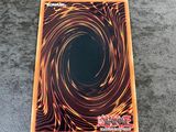 a close up of a card on a table with a black hole in the middle