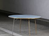 a blue table sitting on a wooden floor in a room