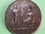 a coin with a picture of a woman and a man on it
