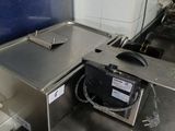 stainless steel counter top in a commercial kitchen with a microwave on it