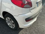 a small white car parked on the side of the road