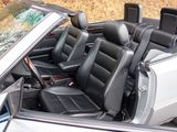 a white car with black leather seats in the back of it