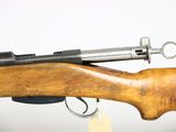 an old rifle with a wooden handle on a white background