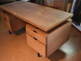 a wooden desk with two drawers on it in a room