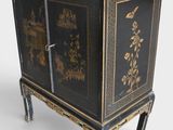 an image of a black and gold cabinet on a stand