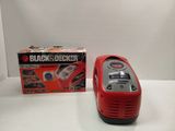 a red and black device sitting next to a black and decker box