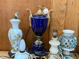 many different vases and lamps on the table