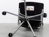 an image of a chair with wheels on a concrete floor