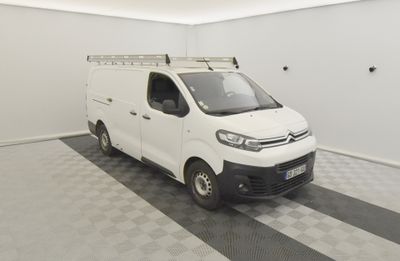 a white van parked in a room with a checkered floor