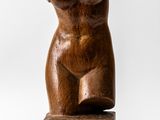 an image of a wooden sculpture of a female torso on a wooden block