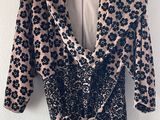 a black and white floral print dress hanging on a hanger