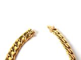 an image of two gold bracelets on a white background