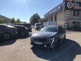 a black car parked in front of a building in a parking lot