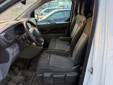 the interior of a white van with the door open and the driver ' s seat down
