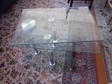 a glass table with a glass top on a rug