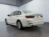 the rear of a white bmw car parked in a garage