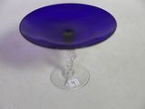 a blue glass cake plate on a white table