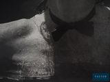 black and white photograph of a man in a bow tie in the water