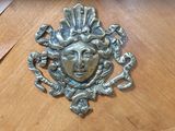 a wooden table with a metal face on it