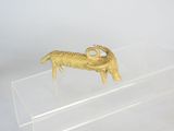 clear acrylic display case with a gold ram figurine on it