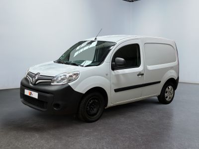 the white van is parked in a large room with a black floor