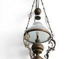 a close up of a light hanging from a chain on a wall