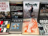 several books on a white table with a white background